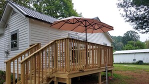 A wooden deck with a staircase leading to a house. - Charming 2-bedroom cabin in Big Clifty with WiFi, AC (Big Clifty)