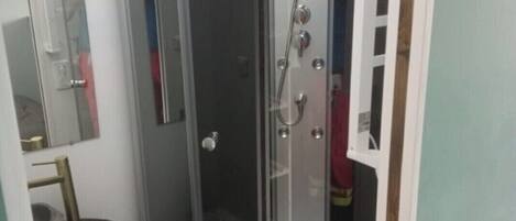 Shower, hair dryer, towels, toilet paper