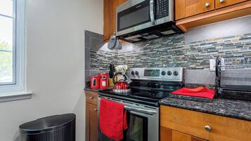 A modern kitchen with stainless steel appliances, a microwave, oven, and a stove.