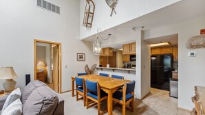 A modern apartment with a dining area, kitchen, and living room. - Lakeside Comfort  • Walk to Lake Dillon • Minutes to Ski Resorts (Frisco)