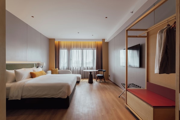 A hotel room with two beds, a small table, a TV, and a wardrobe. - Shō Hotel Penang Waterfront Convention Centre (George Town)