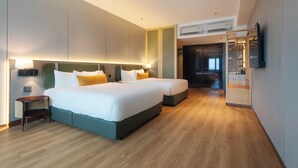 A modern hotel room with two beds, a wooden floor, a large mirror, and a TV mounted on the wall. - Shō Hotel Penang (George Town)