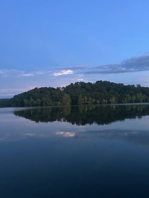 A calm lake with a forested island in the center.