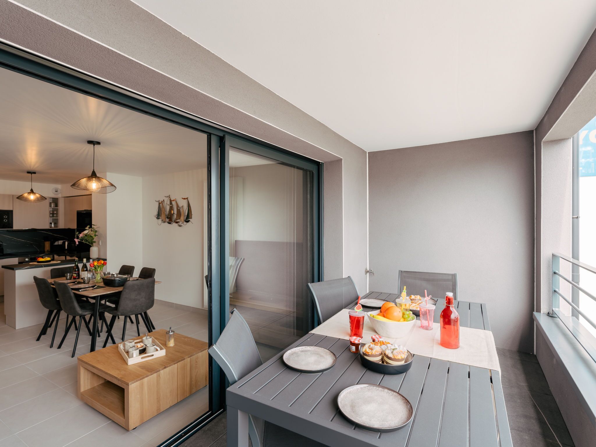 Eine moderne Wohnung mit Essbereich, Küche und Balkon.