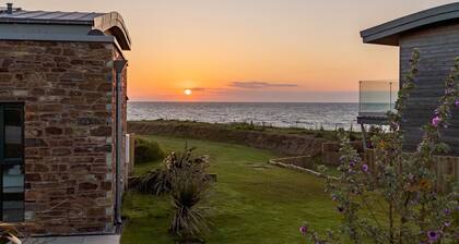 The Beacon is a five bedroomed terraced seafront retreat with incredible views of Widemouth Bay. It
