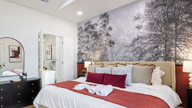 A bedroom with a large bed, a nightstand, a dresser, a mirror, and a wall mural. - Spacious 4-bedroom house Game Room & Spa in fantastic Dallas 11 (Dallas)