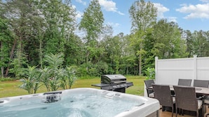 A hot tub with a grill and dining area in a backyard setting. - Hot Tub King Suite 8 min to Downtown Denver (Denver)