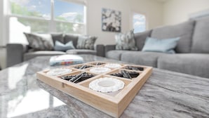 A kitchen with a marble countertop, a wooden tray with a white lid, and a grey sofa in the background. - Hot Tub King Suite 8 min to Downtown Denver (Denver)