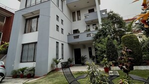 A modern multi-story building with a courtyard.