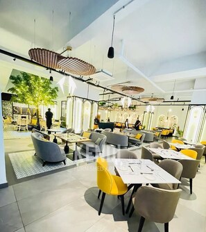 A modern interior with high ceilings, exposed ductwork, and contemporary furniture. - 2 Bedroom at Skynest Residency Westlands (Nairobi)