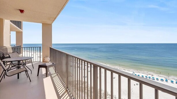 A balcony with a view of the ocean, a table with chairs, and a railing. - Oceanfront Phoenix V Condo Gulf Views & Balcony  OrangeBeach 3Bed 2Bath 14th flr (Orange Beach)