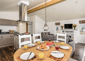 A modern kitchen with a dining area, wooden flooring, and a large window. - 3 bedroom accommodation in Greystoke, Nr Ullswater (Greystoke, Nr Ullswater)