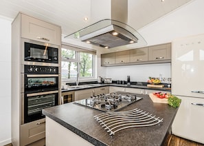A modern kitchen with built-in appliances, a large island, and a view of the outdoors. - 3 bedroom accommodation in Greystoke, Nr Ullswater (Greystoke, Nr Ullswater)