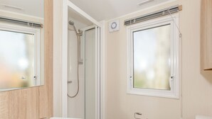 A bathroom with a shower, toilet, and sink. - 3 bedroom accommodation in Talacre, Holywell (Talacre, Holywell)