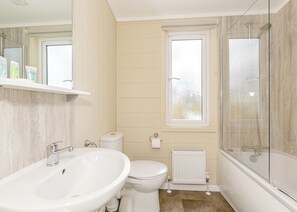 A bathroom with a sink, toilet, and shower. - Willow Tree 3 Premier (Talacre, Holywell)