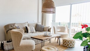 A living room with a sofa, chairs, a coffee table, and a hanging light fixture. - Villa, 3 Terraces, 5-Min Walk to Burriana Beach (Nerja)