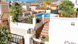 A residential area with a swimming pool, terracotta roof tiles, and a view of distant mountains. - Villa, 3 Terraces, 5-Min Walk to Burriana Beach (Nerja)