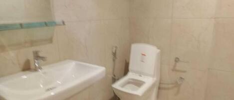 A bathroom with a sink, toilet, and shower.