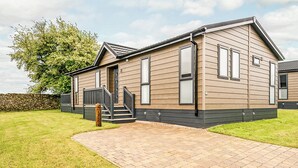 A single-story house with a front entrance, a staircase, and a paved driveway. - 1 bedroom accommodation in Greystoke, Nr Ullswater (Greystoke, Nr Ullswater)