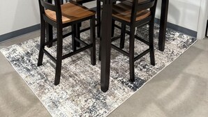 A dining area with a wooden table and four chairs, a black-framed mirror, and a shelf with decorative items. - Calming Comfort Stay (Clovis)