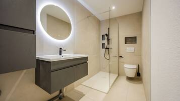 Shower, hair dryer, towels, toilet paper