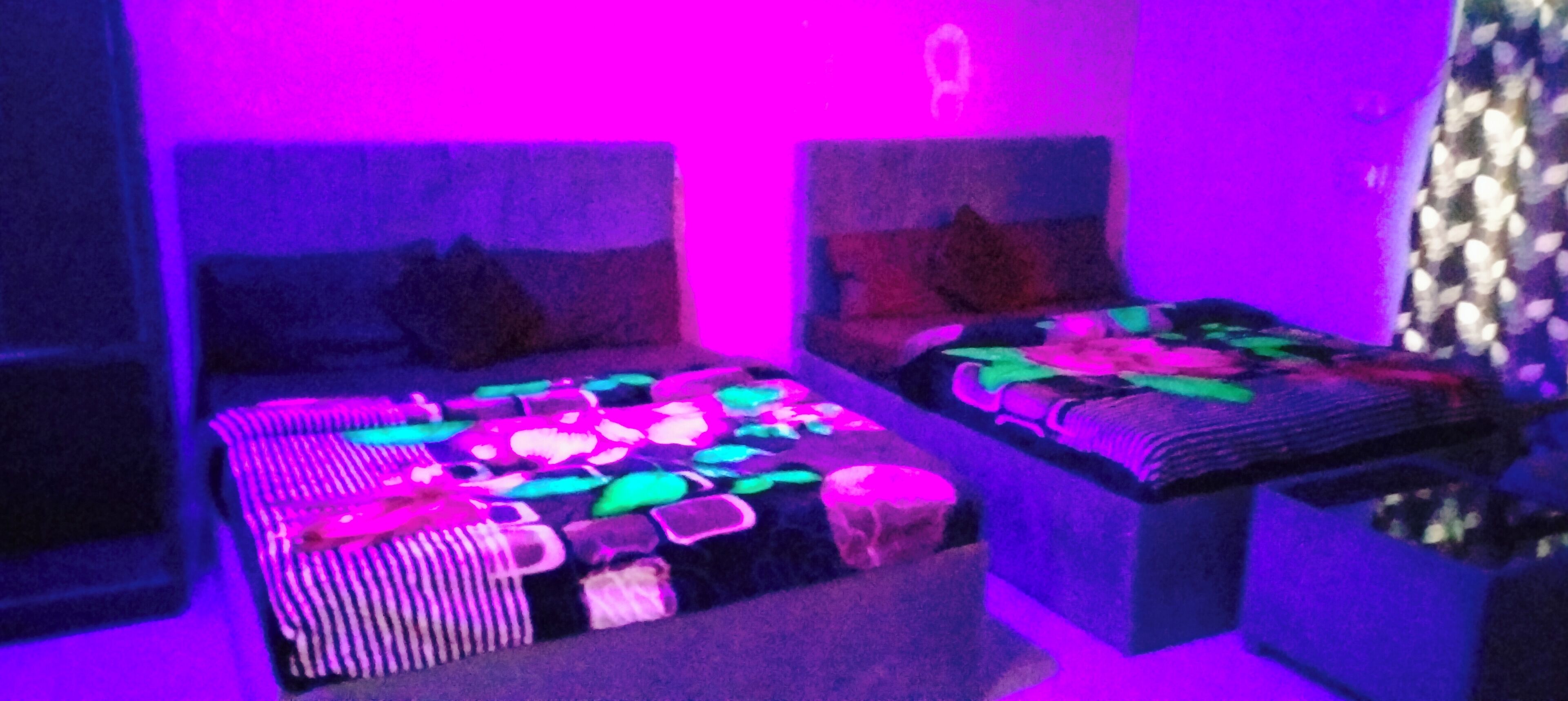 A room with two beds, each with a patterned bedspread.