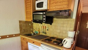 A compact kitchen with a microwave, toaster, and coffee maker.
