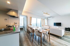 A modern, well-lit apartment with a kitchen, dining area, and living room. - Twinberry CHITOSE (Chitose)