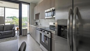 A modern kitchen with stainless steel appliances, a built-in oven, and a water dispenser.