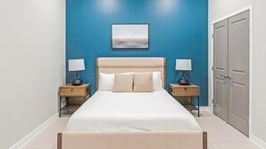 A bedroom with a bed, two nightstands, a headboard, a wall-mounted picture, and a wardrobe. - Landing | Stunning 1BD in Fountain Heights (Birmingham)