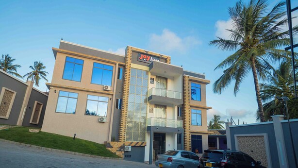 A two-story building with a sign reading "Jay Inn". - Joy Inn Hotel (Dar es Salaam)
