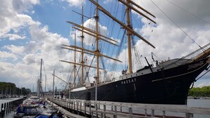 A large sailing ship docked at a marina with a wooden pier and smaller boats nearby. - Villa Scharbeutz Pönitz, spacious, quiet, central (Scharbeutz)
