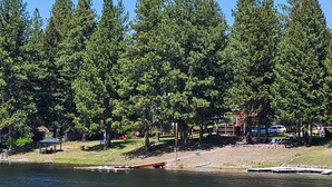 A lake with a dock and a sign indicating no parking.
