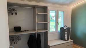 A laundry room with a large window, a drying rack, and a bag labeled "LAUNDRY". - 5 minutes from the lake house with garden in residence with swimming pool (Padenghe Sul Garda)