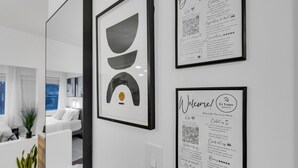 A modern hotel room with a minimalist design, featuring a large window, a comfortable bed, and a small potted plant. - Sherbrooke 101 Downtown Montreal | Balcony, Queen Bed, Sofa Bed, Parking & TV (Montréal)
