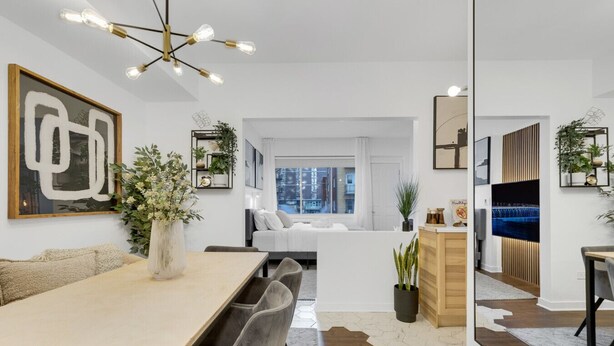 A modern living room with a dining area, a sofa, a coffee table, and a TV. - Sherbrooke 101 Downtown Montreal | Balcony, Queen Bed, Sofa Bed, Parking & TV (Montréal)