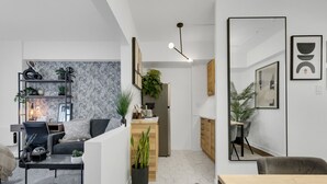 A modern kitchen with a wooden countertop, a built-in oven, and a hanging light fixture. - Sherbrooke 101 Downtown Montreal | Balcony, Queen Bed, Sofa Bed, Parking & TV (Montréal)