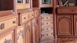 A spacious room with a large wooden cabinet, a mirror, and a herringbone-patterned floor. - Tiranoexpress 2 floor (Tirano)