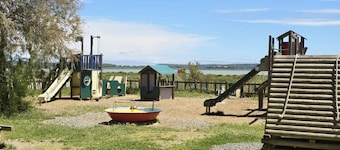 On the edge of a salt pond, house with terrace facing the water and pink flamingos