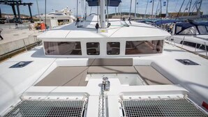 A boat deck with a central mast, multiple windows, and a covered area. - Stay Together, "Somewhere" - 4 Bed & 4 Bath - Catamaran in Key West (Key West)