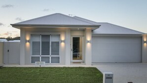 A modern single-story house with a garage, a front door, and a small porch area. - Nessie`s Nook Relax in fully Air-Conditioned Style (Dunsborough)