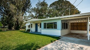 A single-story house with a front porch, a garage, and a well-maintained lawn.