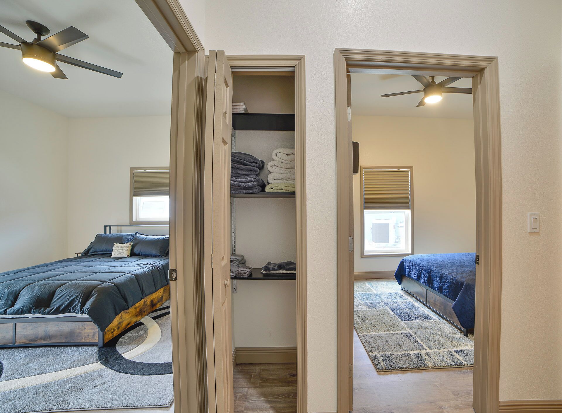 A bedroom with a bed, a closet, and a window.