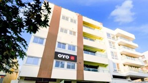 A multi-story building with a prominent 'OYO' sign on the facade. - HOTEL GREENLANE SUITES (Hyderabad)