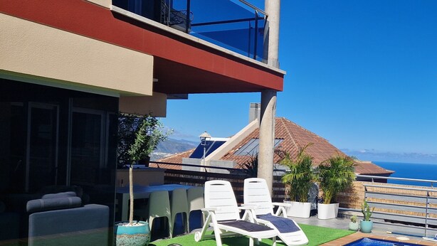 A rooftop pool area with lounge chairs, a small pool, and a view of the ocean. - Atlantic Blue: Private Heated Pool and Ocean Views (Santa Úrsula)