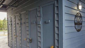 A row of grey metal lockers with numbers 302, 304, and 204, and a metal plaque on the wall.