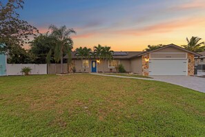 A single-story house with a garage, a front lawn, and a driveway.