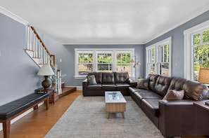 A living room with a sofa set, a coffee table, and a lamp.