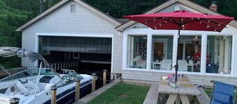 Stunning lakefront home with a boathouse, private dock, firepit and lake views