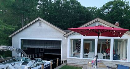 Stunning lakefront home with a boathouse, private dock, firepit and lake views